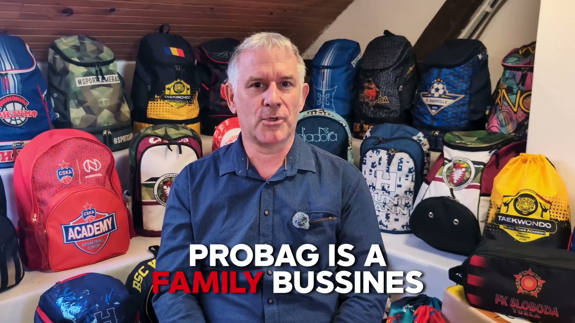 Pro-Bag founder talking about the family business, custom backpacks behind him
